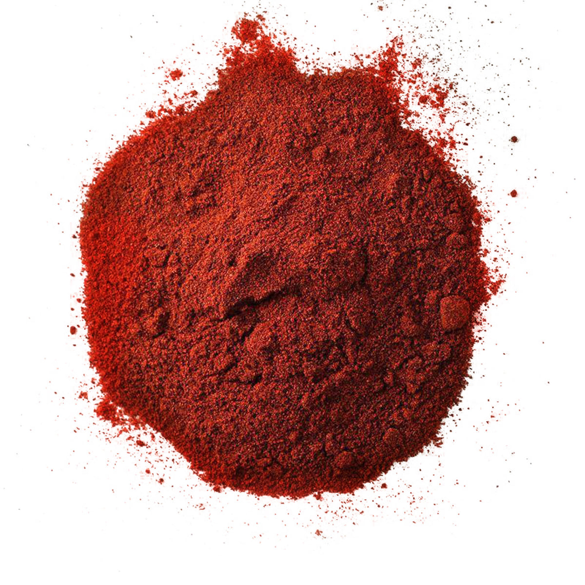 Overhead view of a pile of deep red spice powder on a white background