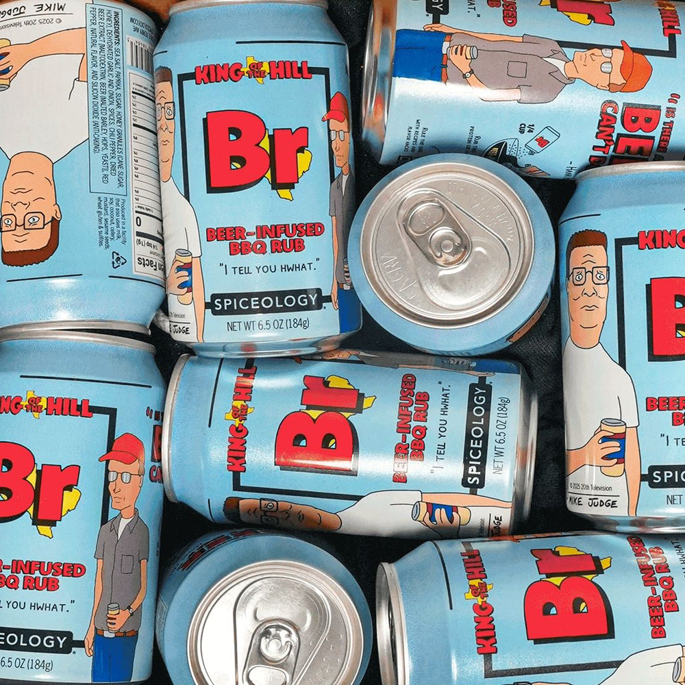 Overhead view of multiple Spiceology King of the Hill Beer Infused BBQ Rub branded spice cans arranged closely together