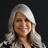 Professional headshot of a smiling woman with silver hair