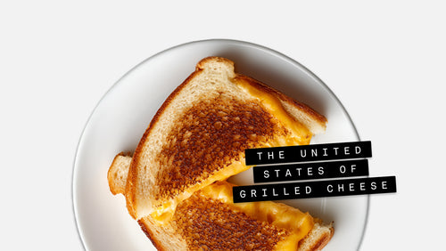 Grilled cheese sandwich on a white plate with The United States of Grilled Cheese text overlay