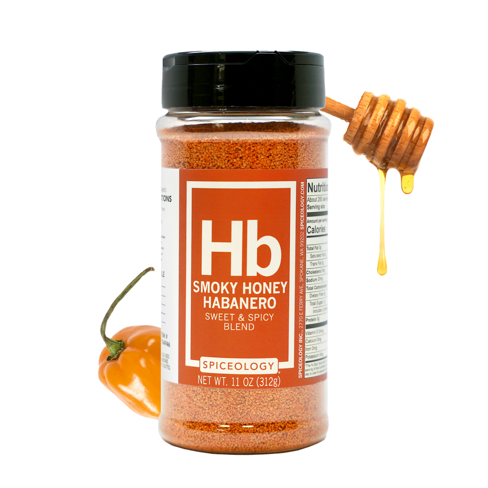 A jar of Smoky Honey Habanero spice blend with a honey dipper drizzling honey and a fresh habanero pepper beside it. The label is red and white, showing the Hb symbol and product information.