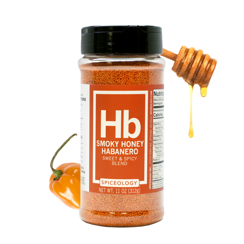 A jar of Smoky Honey Habanero spice blend with a honey dipper drizzling honey and a fresh habanero pepper beside it. The label is red and white, showing the Hb symbol and product information.
