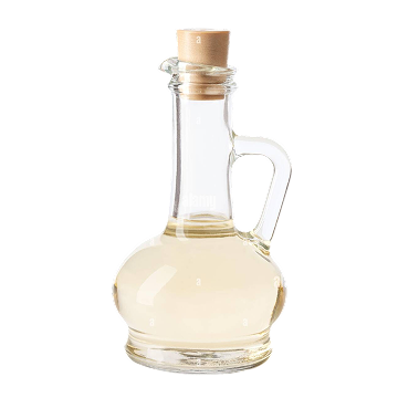 Clear glass bottle with cork stopper containing a liquid on a white background