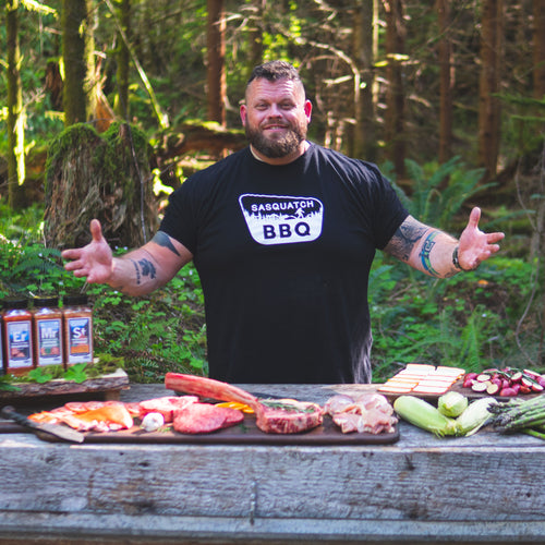 Sasquatch BBQ logo featuring a rustic bigfoot silhouette grilling over an open flame at night